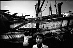 India, Tamil Nadu ,february 2005.<br><br>Chennai, children play at the distroyed boats.<br><br>Victims of the Tsunami are struggling to survive after the Tsunami, their main business as fisherman have been made impossible by destroyed boats and nets.<br>while improvising and take the risk to fish the sea using a inferior boat, local people don't want to eat the fish, so prizes go down to 20% of before.<br><br>The Indian Government claims to have the situation under control and don't accept foreign aid, in the meantime they move fisherman away from the beaches to remote areas, where their chances of survival will be even less.<br>