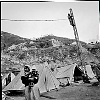 Pakistan, Kashmir  dec2005/febr2006<br>Fixing electricity in on of the camps.<br><br>More than 70.000 people have lost their lives during the earthquake in the Pakistan Kashmir regions on October 8.<br>Cities like Balakot , near the epical center report close to 100% destroyed homes that are beyond rebuilding.<br>In the mountain regions of Kashmir, people are difficult to reach and some area's can only be accessed after spring arrives.<br>This creates a huge flood of people that flee the mountains during wintertime, facing the dangerous landslides,<br>to arrive in the hands of the Aid agencies who have a huge task, while some have lack of funding.<br>The fear of total isolation, outbreak of diseases, and traumatized victims is a  long task for the future.<br>In the tents, life tries to find it's rules again, the refugees  try to forget all they have lost and hope for a better future.<br>
